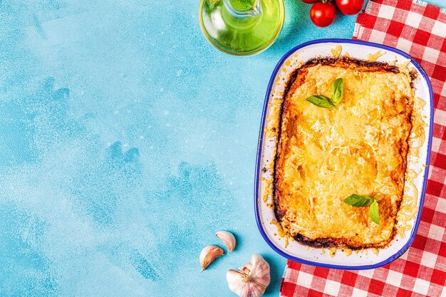 Traditional italian lasagna with vegetables, minced meat and cheese, top view, copy space.