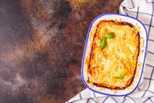 Traditional italian lasagna with vegetables, minced meat and cheese, top view, copy space.