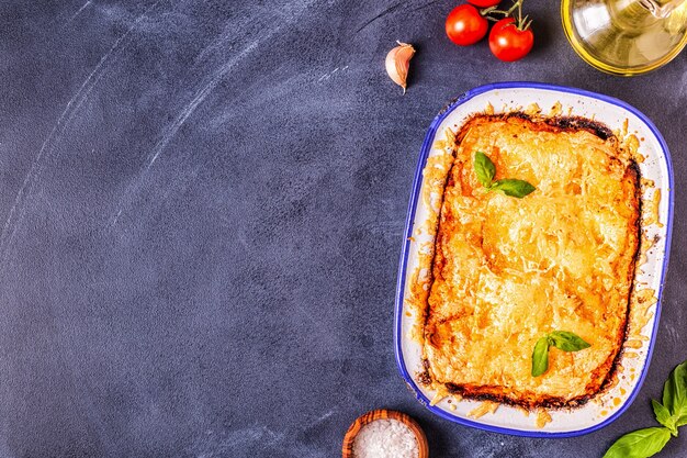 Traditional italian lasagna with vegetables, minced meat and cheese, top view, copy space.