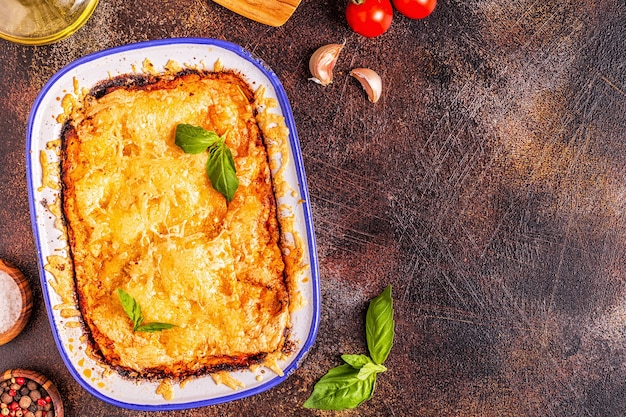 Traditional italian lasagna with vegetables, minced meat and cheese, top view, copy space.