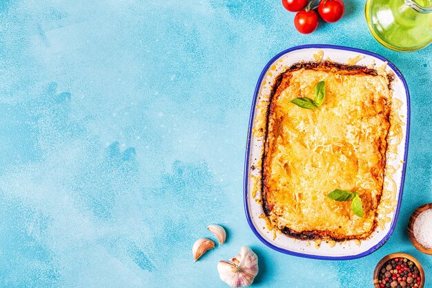 Traditional italian lasagna with vegetables, minced meat and cheese, top view, copy space.