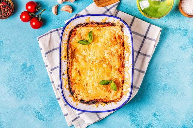 Traditional italian lasagna with vegetables, minced meat and cheese