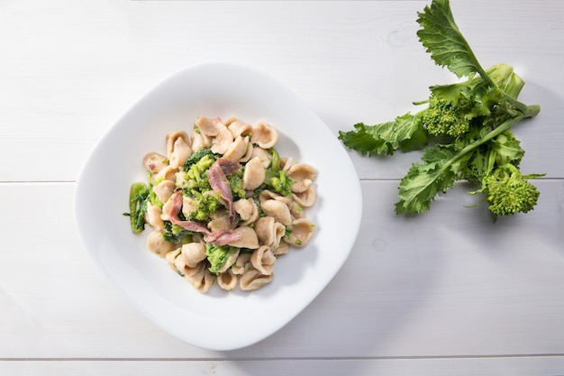 Traditional italian Orecchiette pasta with turnip greens and salted anchovies