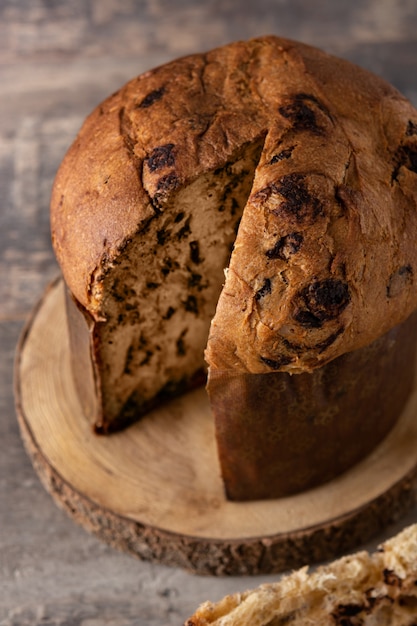 Traditional Italian panettone for Christmas on rustic wooden table