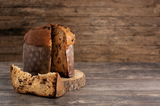 Traditional Italian panettone for Christmas on rustic wooden table