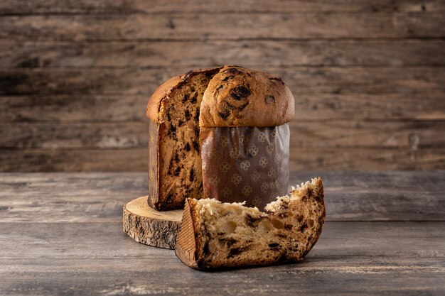 Traditional Italian panettone for Christmas on wooden table