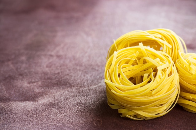 Traditional italian pasta fettuccine on a wooden table