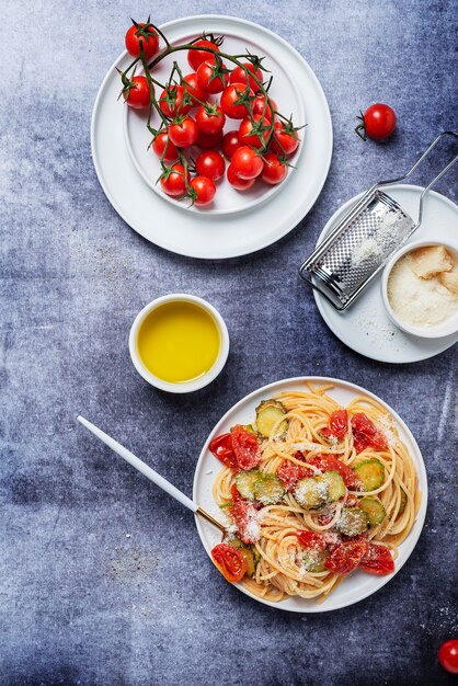 Traditional Italian pasta with tomato, zucchini and parmesan