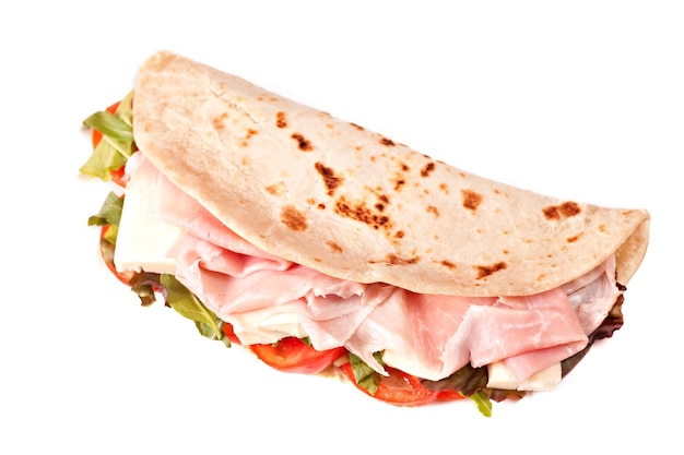 Traditional Italian piadina with ham cheese tomato and salad