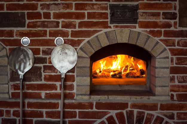 Traditional italian Pizza oven burning wood and flames in fireplace