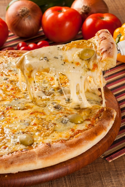 Traditional italian pizza with ingredients on wooden.