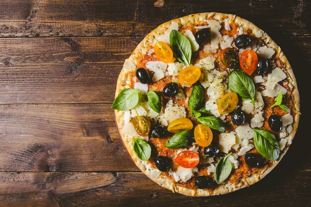 Traditional italian pizza on wooden table