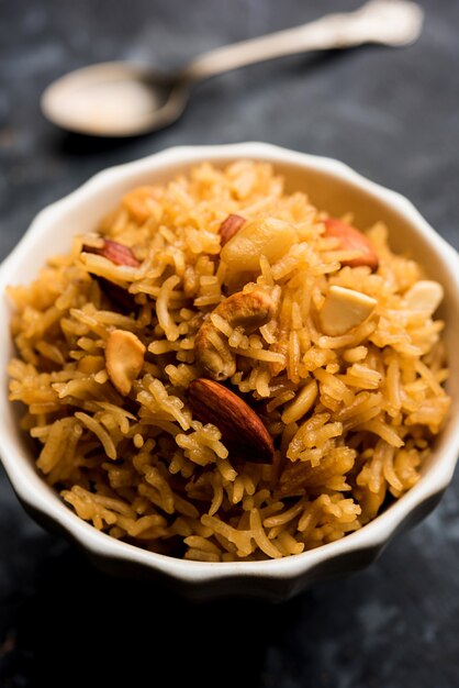 Traditional Jaggery Rice or Gur wale chawal in Hindi, served in a bowl with spoon. selective focus