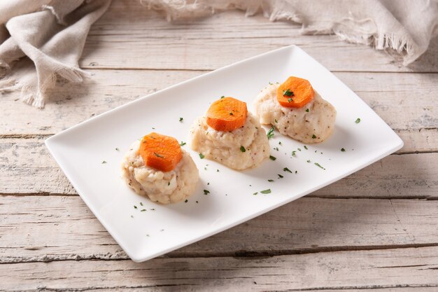 Traditional Jewish gefilte fish on wooden table