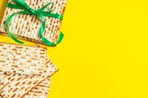 Traditional Jewish matzo on a yellow background Happy Passover Pesach religious holiday celebration