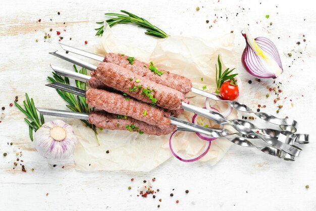 Traditional kebab with rosemary and onions. Grilled veal skewers. Top view. Free space for your text.
