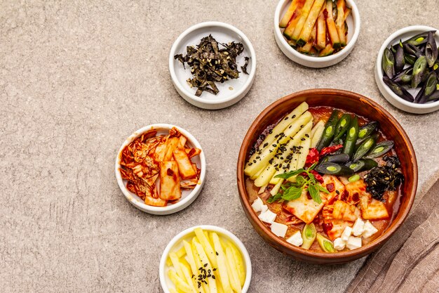 Traditional Korean spicy soup with kimchi, tofu, vegetables. Hot dish for healthy meal