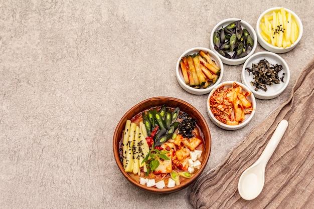 Traditional Korean spicy soup with kimchi, tofu, vegetables. Hot dish for healthy meal