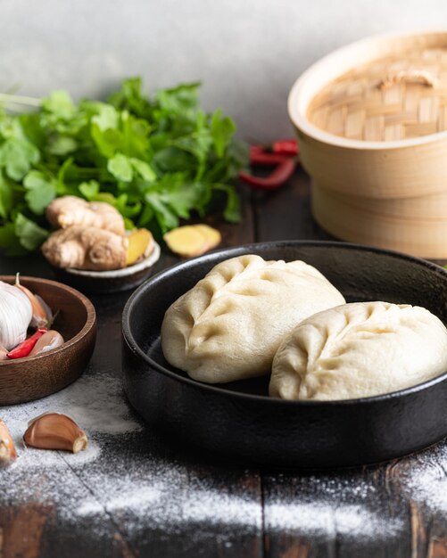 Traditional Korean steamed buns, pyanse or pigodi, on dark wooden background, selective focus