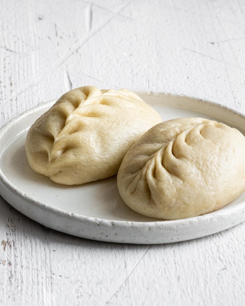 Traditional Korean steamed pie, pyanse or pigodi, on white wooden background, selective focus