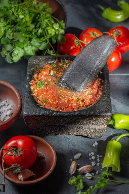 Traditional latin american mexican tomato sauce salsa chilean chancho en piedra in stone mortar