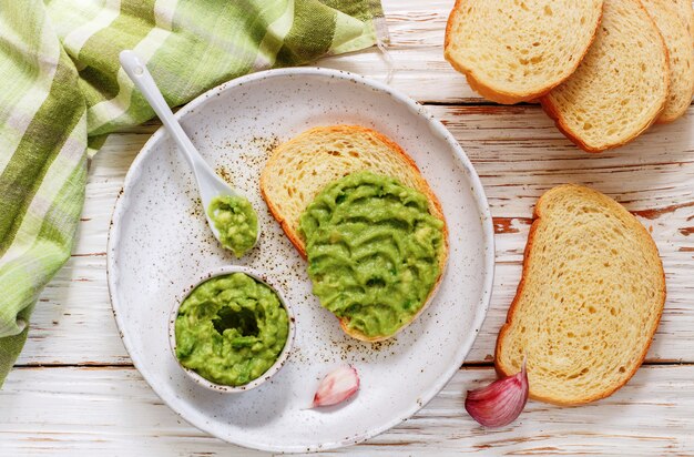 Traditional Latinamerican mexican guacamole sauce  and avocado sandwiches