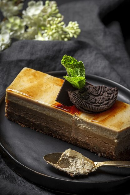 Traditional luxurious French pastries with mint leaves on dark plate