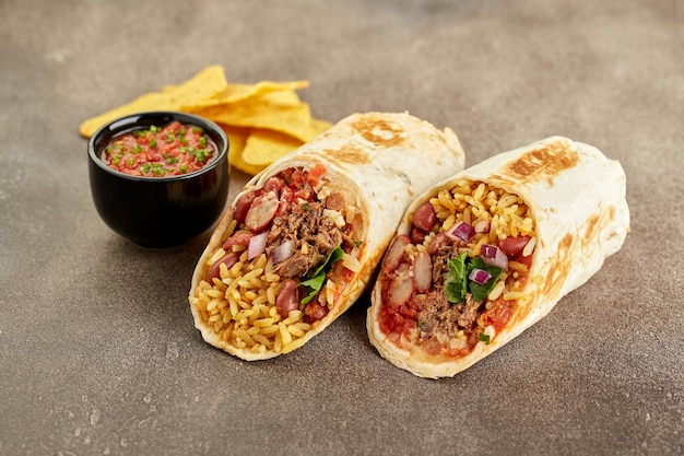 Traditional Mexican Beef Burrito with Nachos Chips and Salsa Sauce