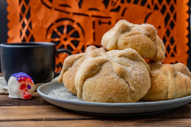 Traditional Mexican bread of the dead also known as Pan de Muerto on traditional Mexican table home