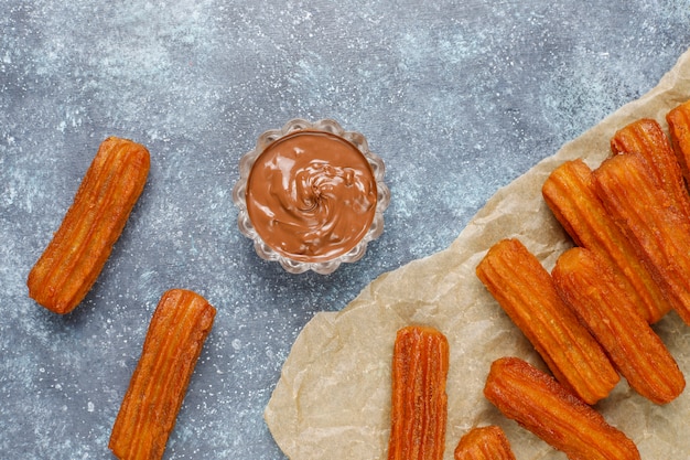 Photo traditional mexican dessert churros with chocolate, top view