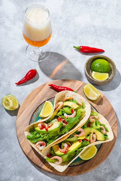 Traditional mexican fast food mexican shrimp and avocado tacos with lime and spice peppers and light