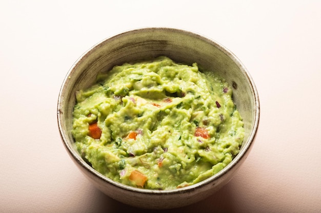 Traditional Mexican Guacamole sauce made from avocado lime red onion tomatoes cilantro