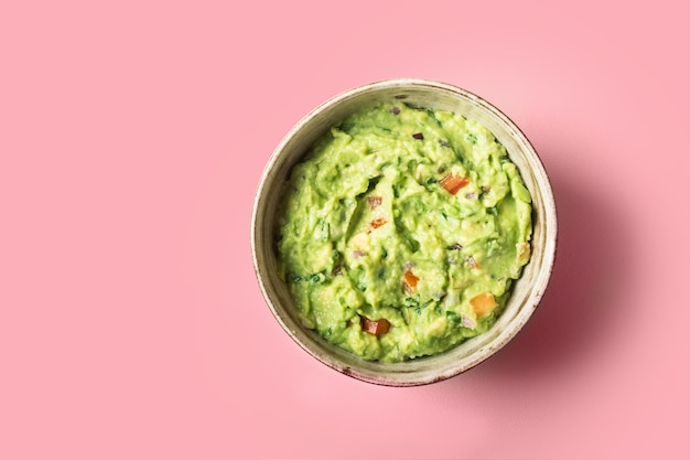 Traditional Mexican Guacamole sauce made from avocado lime red onion tomatoes cilantro