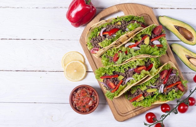 Traditional mexican tacos with beef tomato and avocado