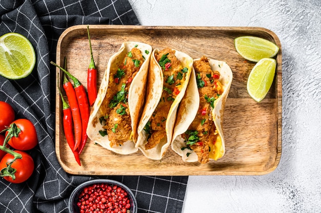 Traditional Mexican tacos with parsley, cheese and chili peppers