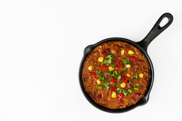 Traditional mexican tex mex chili con carne in a frying pan on white