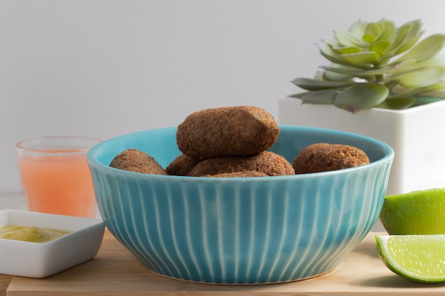 Traditional middle eastern cuisine snack, Kibbeh (kibe) in a blue bowl.