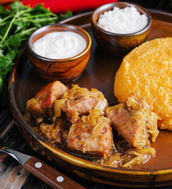 Traditional Moldavian Romanian cornmeal porridge with meat and sauce