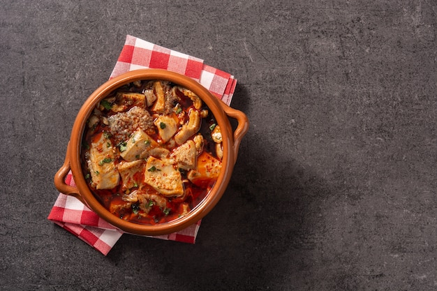 Traditional mondongo or el menudo soup on black stone