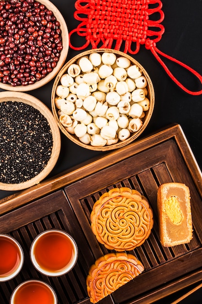 Traditional mooncakes on table setting with teacup. 