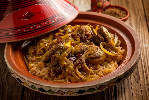 Traditional moroccan chicken tajine with rice and vegetables