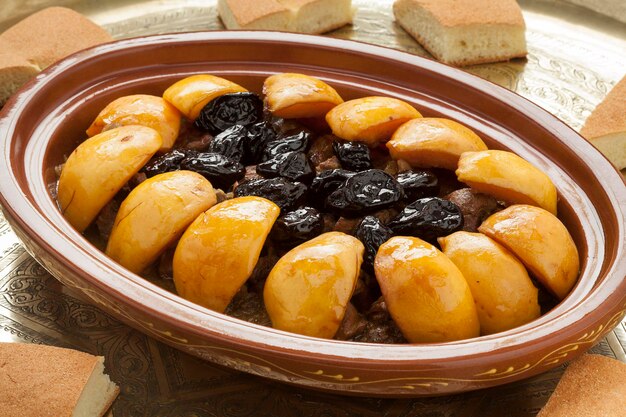 Traditional Moroccan festive dish with meat quinces and prunes close up