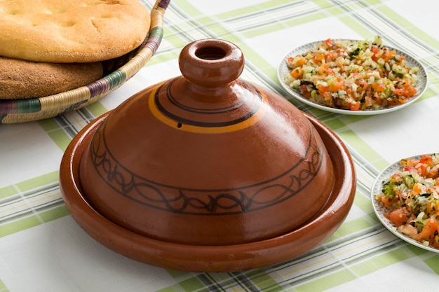 traditional moroccan tagine with salad and bread