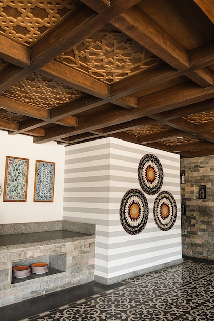 Traditional oriental bar interior design with wooden and marble
furniture colorful ornamental plates on the wall