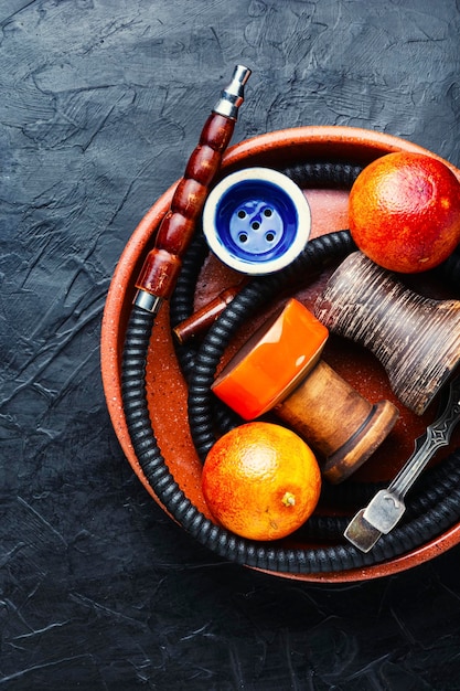 Traditional oriental hookah with orange tobacco