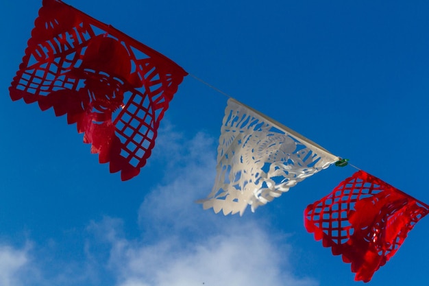 Traditional papel picado decorating a garden.