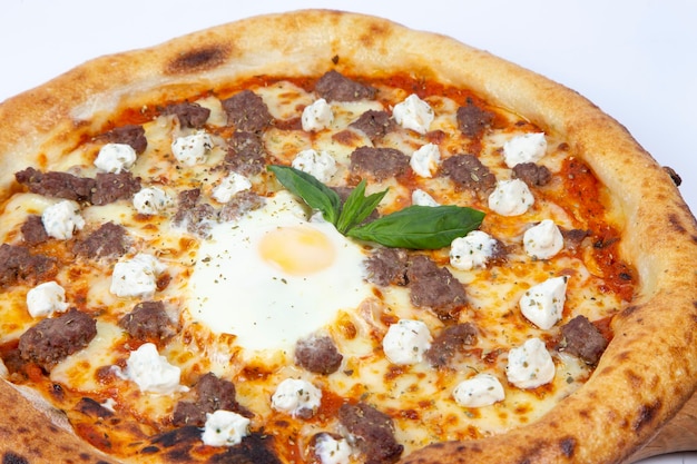 Traditional pizza served with meat and egg