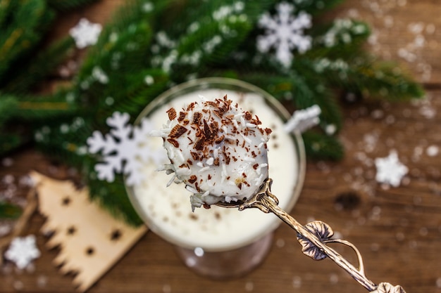 Traditional prune dessert with walnuts and whipped sour cream with sugar. New Year's sweet treat concept