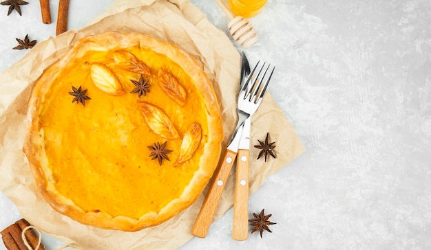 Traditional pumpkin pie on a light table. copy space