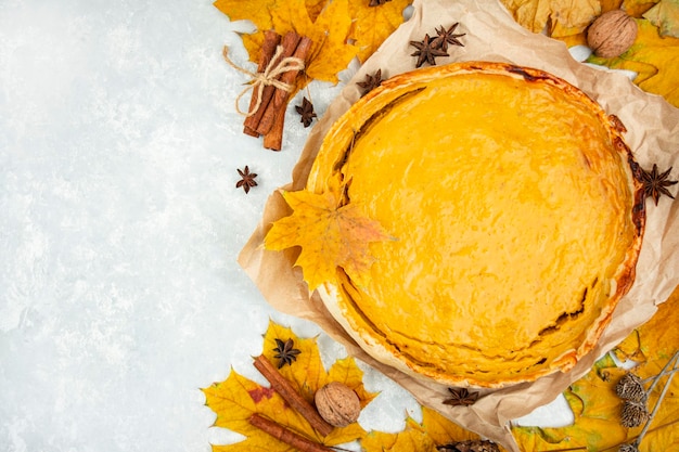 Traditional pumpkin pie on a light table View from above Copy space